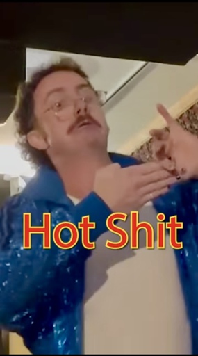 Tom Cardy trying to fit his fingers together awkwardly with the words “hot shit” shown in the centre