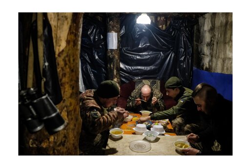 On November 25, 2018, I was in Spain when I saw the news that Russian forces had seized three Ukrainian naval vessels in the Kerch Strait, near the Sea of Azov. I immediately began arranging logistics and traveled to the region. After obtaining the necessary accreditations from both the Ukrainian and Russian sides, I made my way to the frontlines of the conflict in the Donbas region, where Ukrainian forces were engaged in a tense standoff with Russian-backed separatists.

I embedded with Ukrainian soldiers and spent time living in a frontline bunker, documenting their daily routines and the low-intensity warfare that, even then, signaled the beginning of what would later become the full-scale invasion in 2022.

In this photo, Ukrainian soldiers share a hot meal after returning from patrol duty near the frontline.